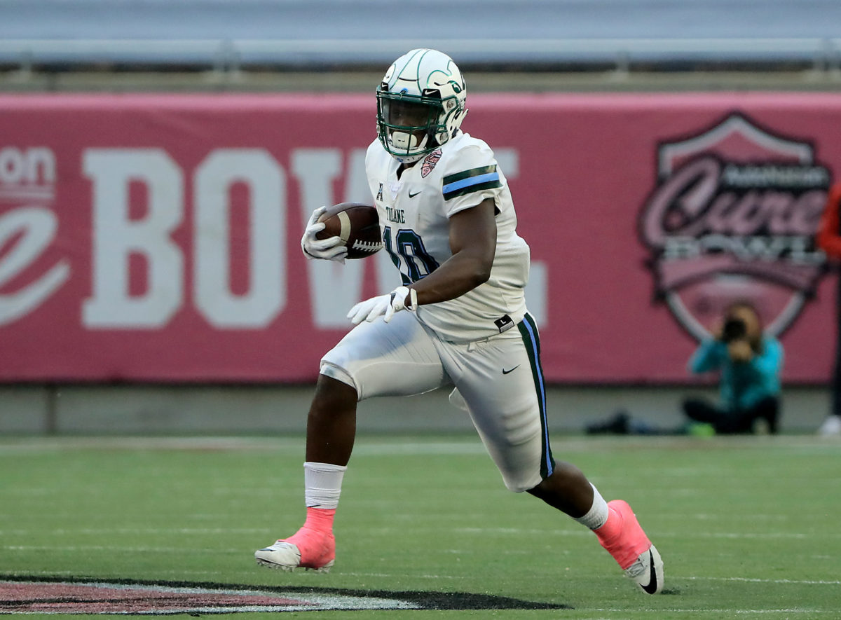 A Tulane player runs the ball during the Cure Bowl.