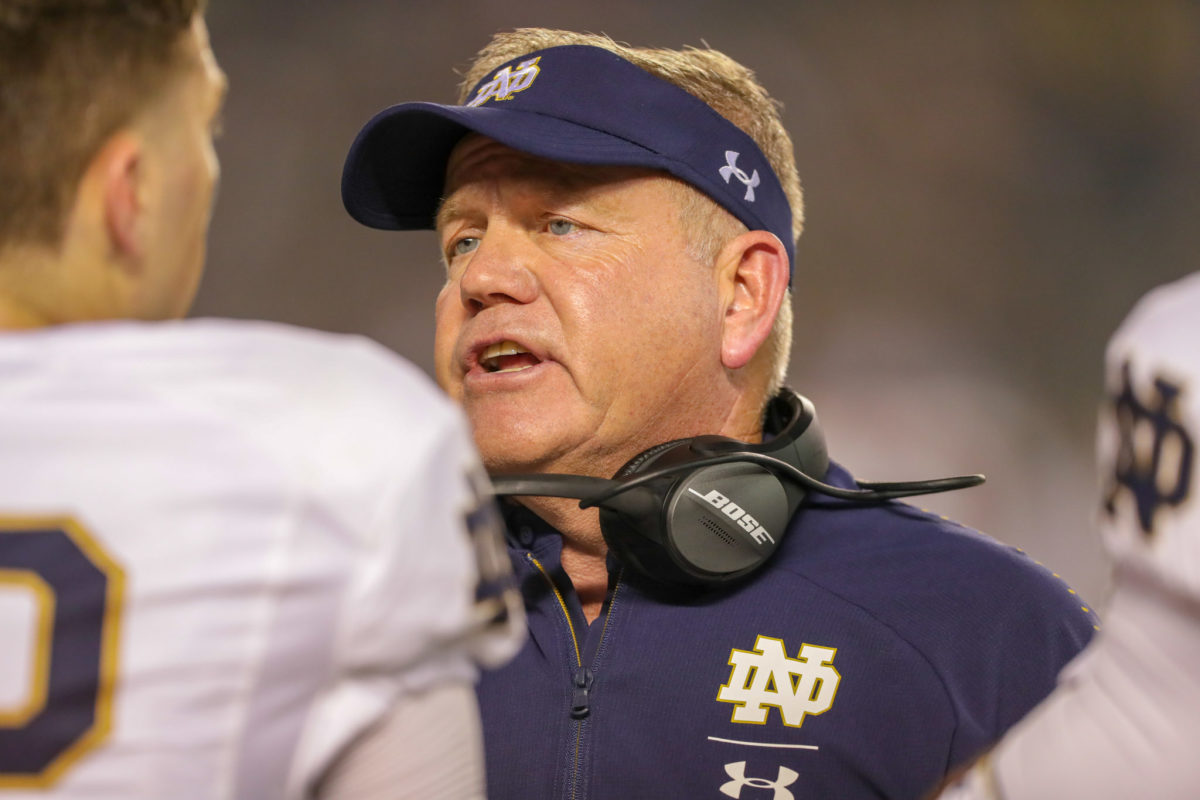 A closeup of Notre Dame football coach Brian Kelly talking to his players.