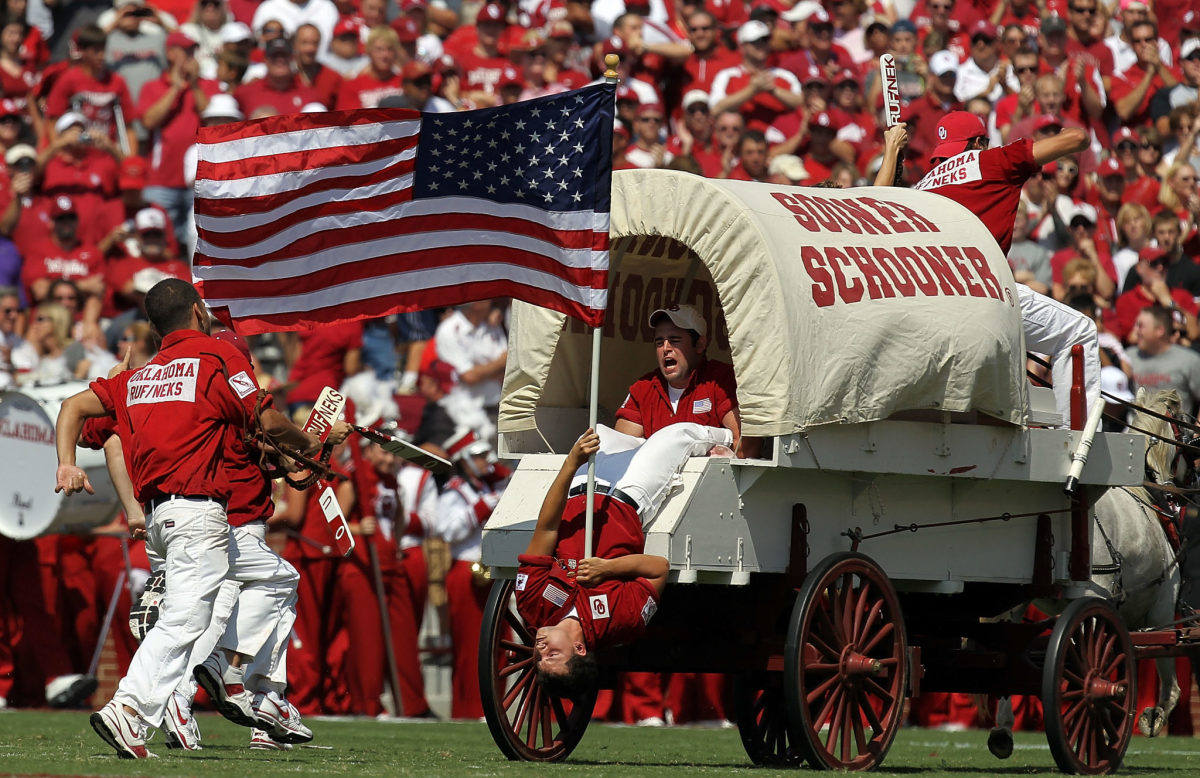 The Oklahoma Sooner Schooner carries the American flag on the anniversary of September 11 at Gaylord Family Oklahoma Memorial Stadium.