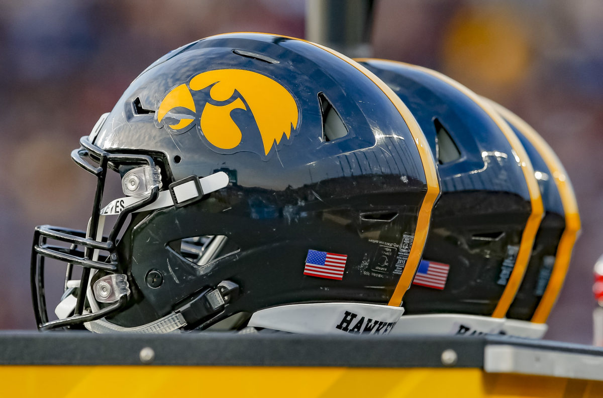 A group of Iowa Hawkeyes football helmets.
