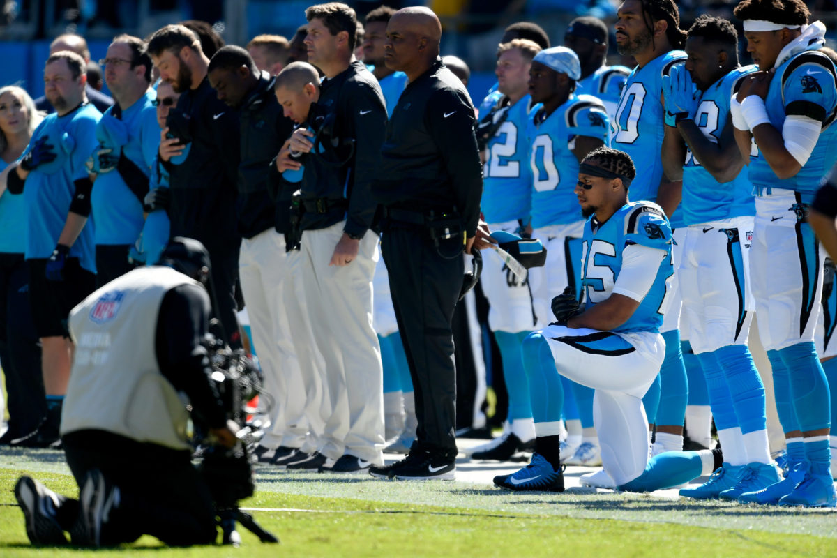 Eric Reid of the Panthers kneels during the national anthem.