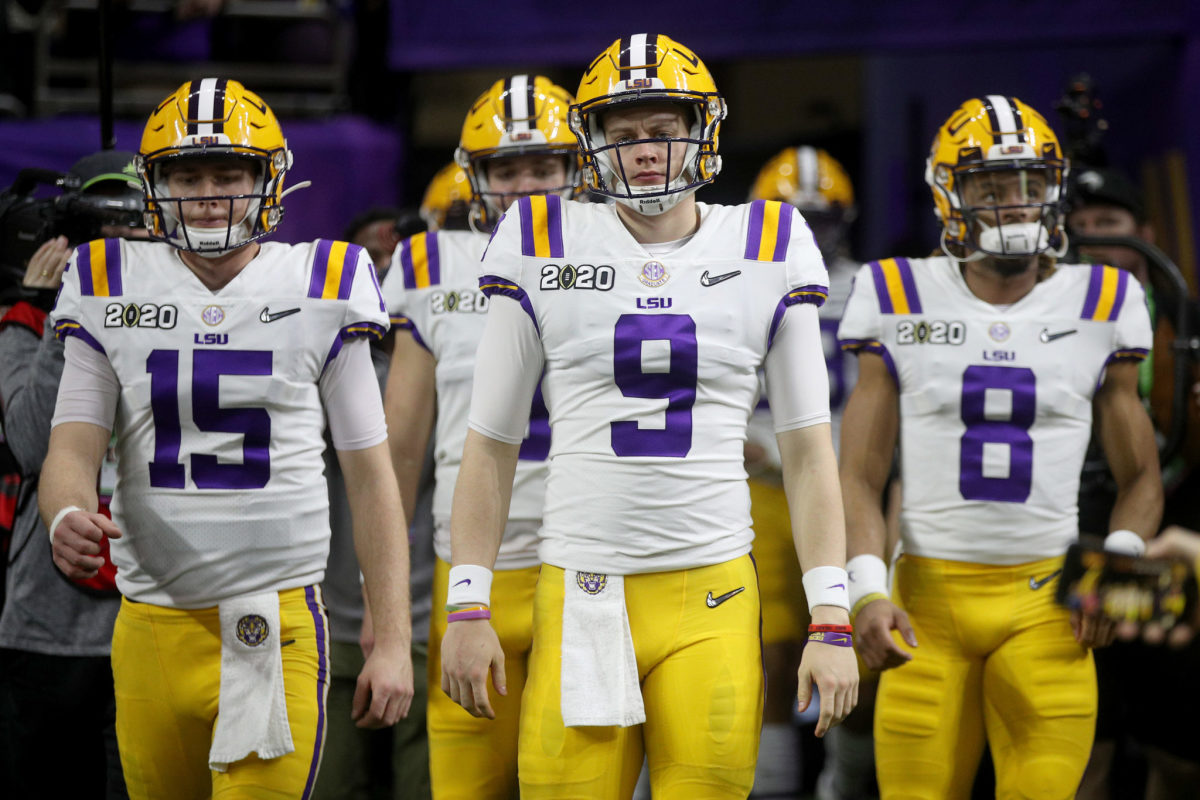 LSU players, including quarterbacks Joe Burrow and Myles Brennan, take the field before the title game.
