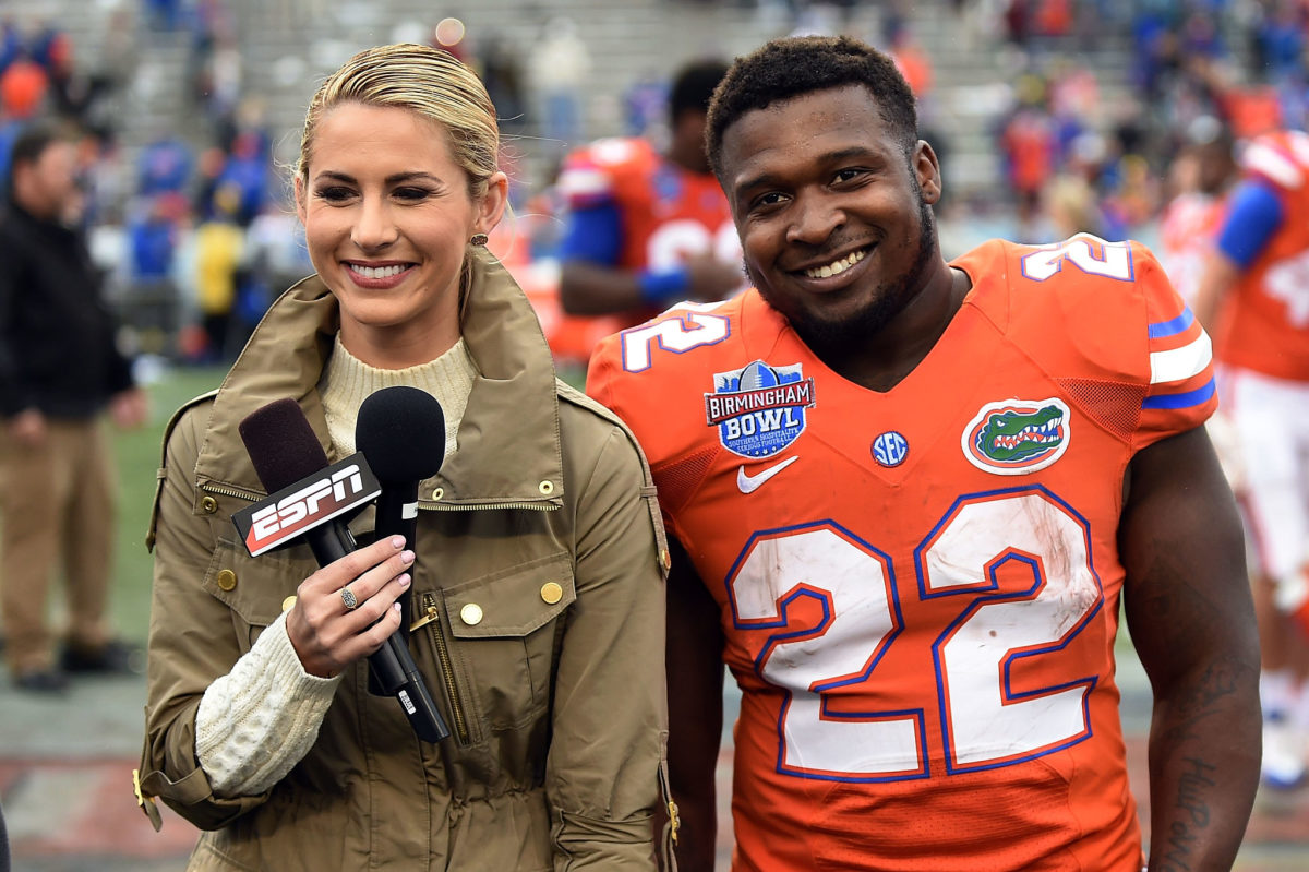 Laura Rutledge of ESPN stands with a Florida player.