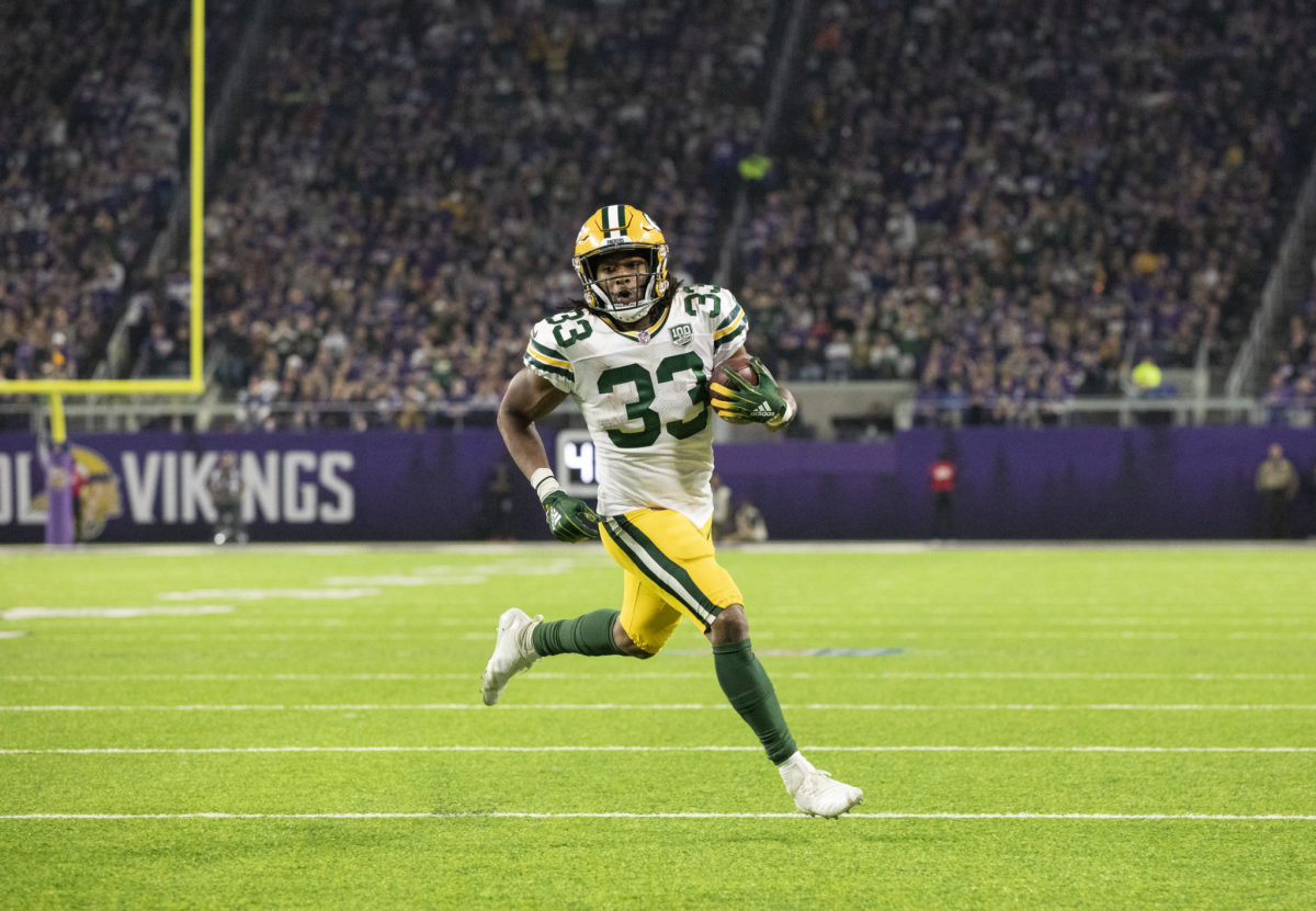 Green Bay Packers running back Aaron Jones running with the football.