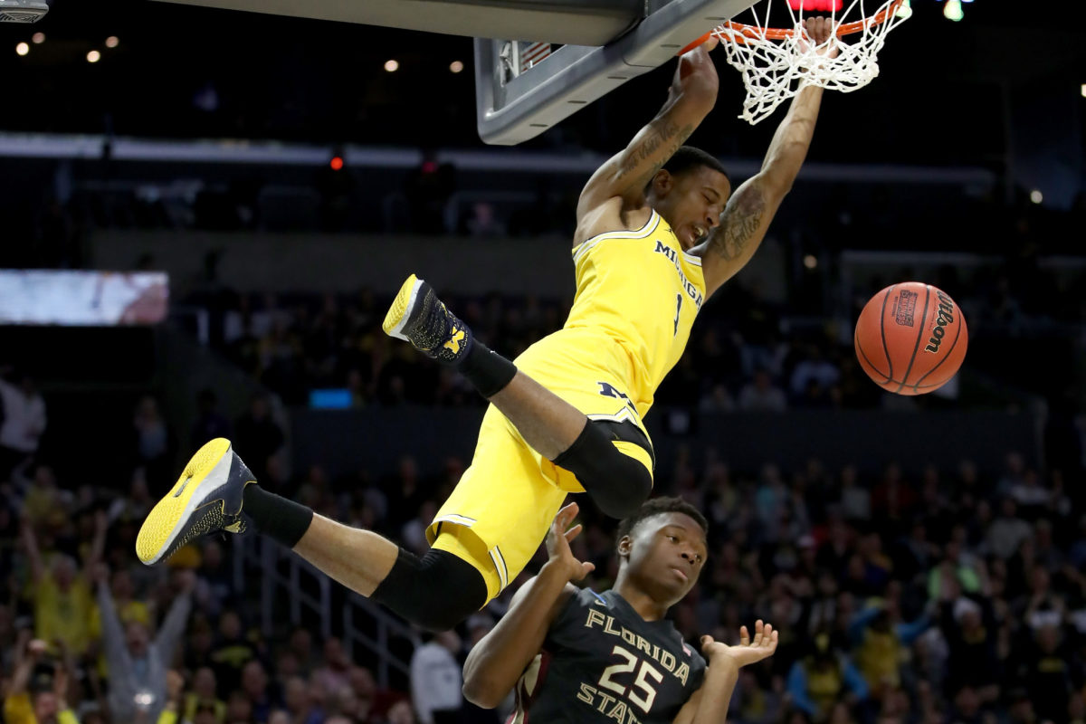 Charles Matthews of the Michigan dunks the ball in the first half against Mfiondu Kabengele #25 of the Florida State Seminoles.