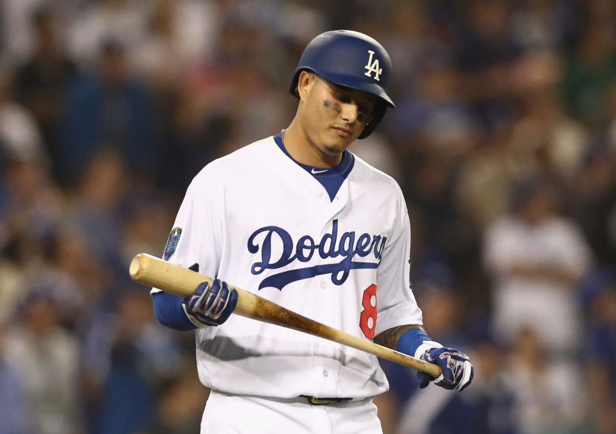 manny machado holds his bat during a game for the dodgers