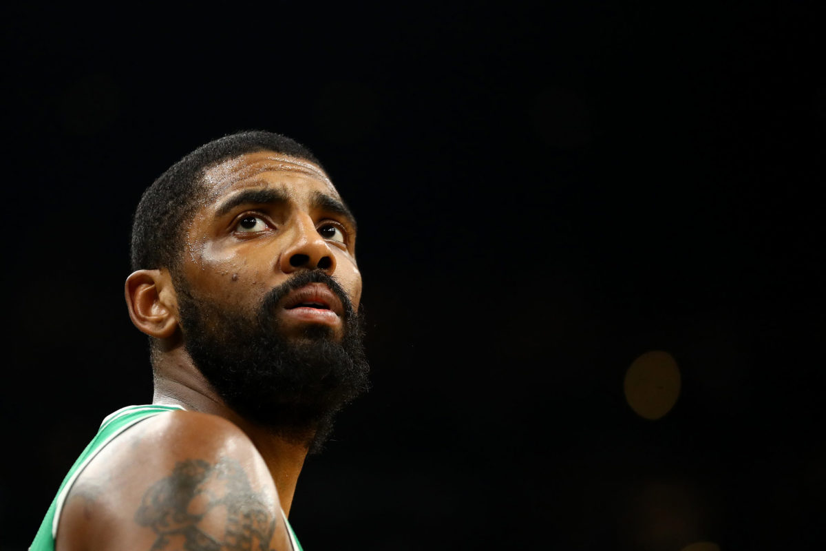 kyrie irving looks off the court during a game in boston