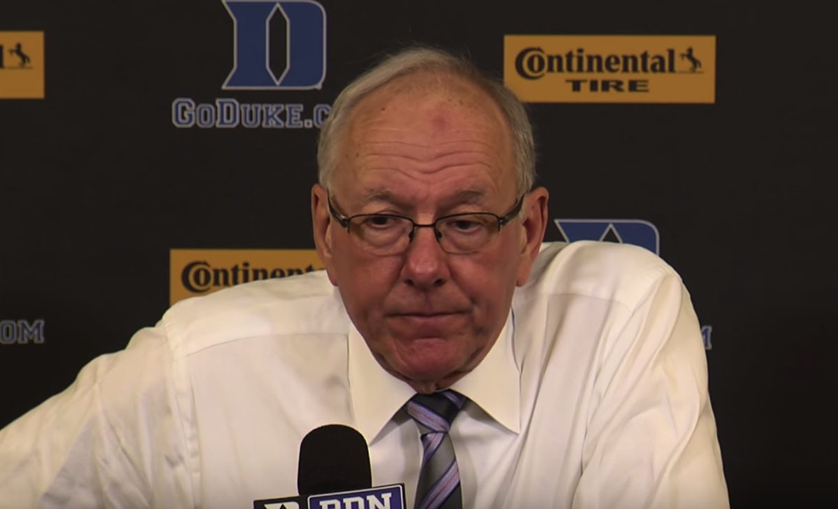Jim Boeheim frowns at a press conference.