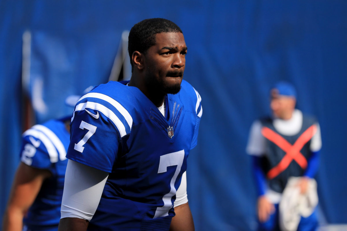 Indianapolis Colts quarterback Jacoby Brissett runs onto the field.