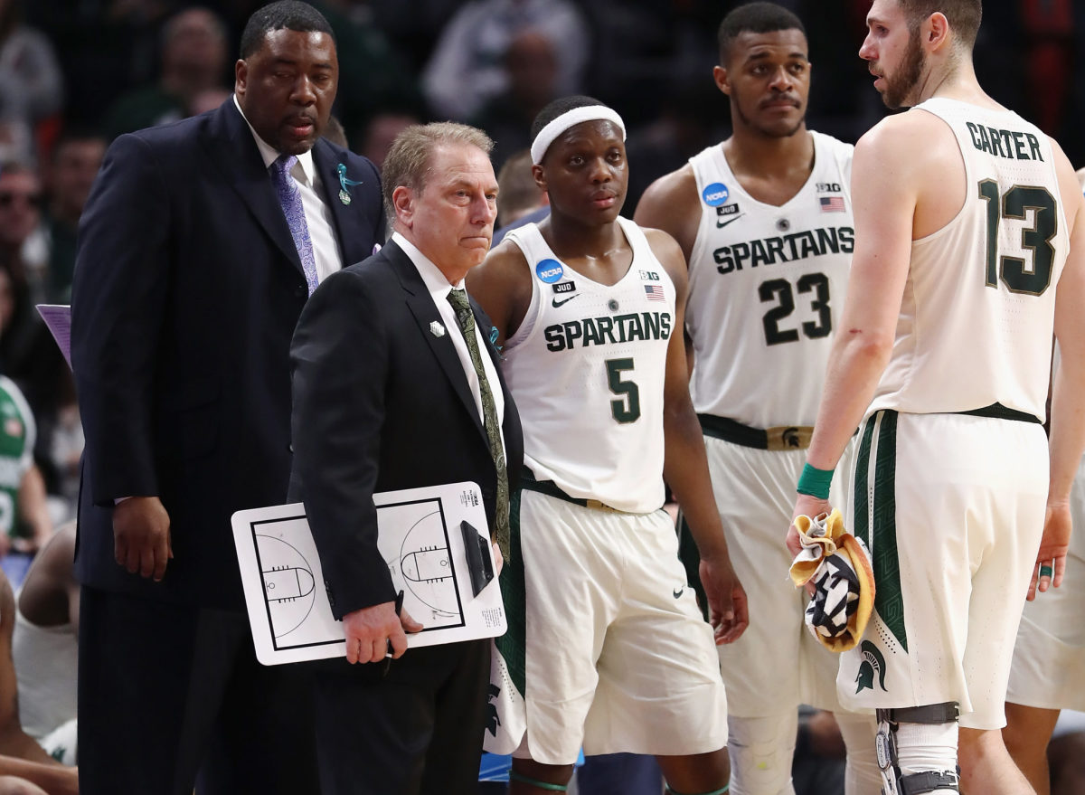 Tom Izzo holding a clipboard on the Michigan State Spartans sideline.