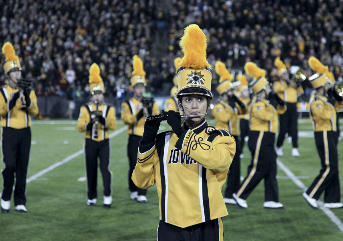 A member of Iowa marching band performing during a football game.