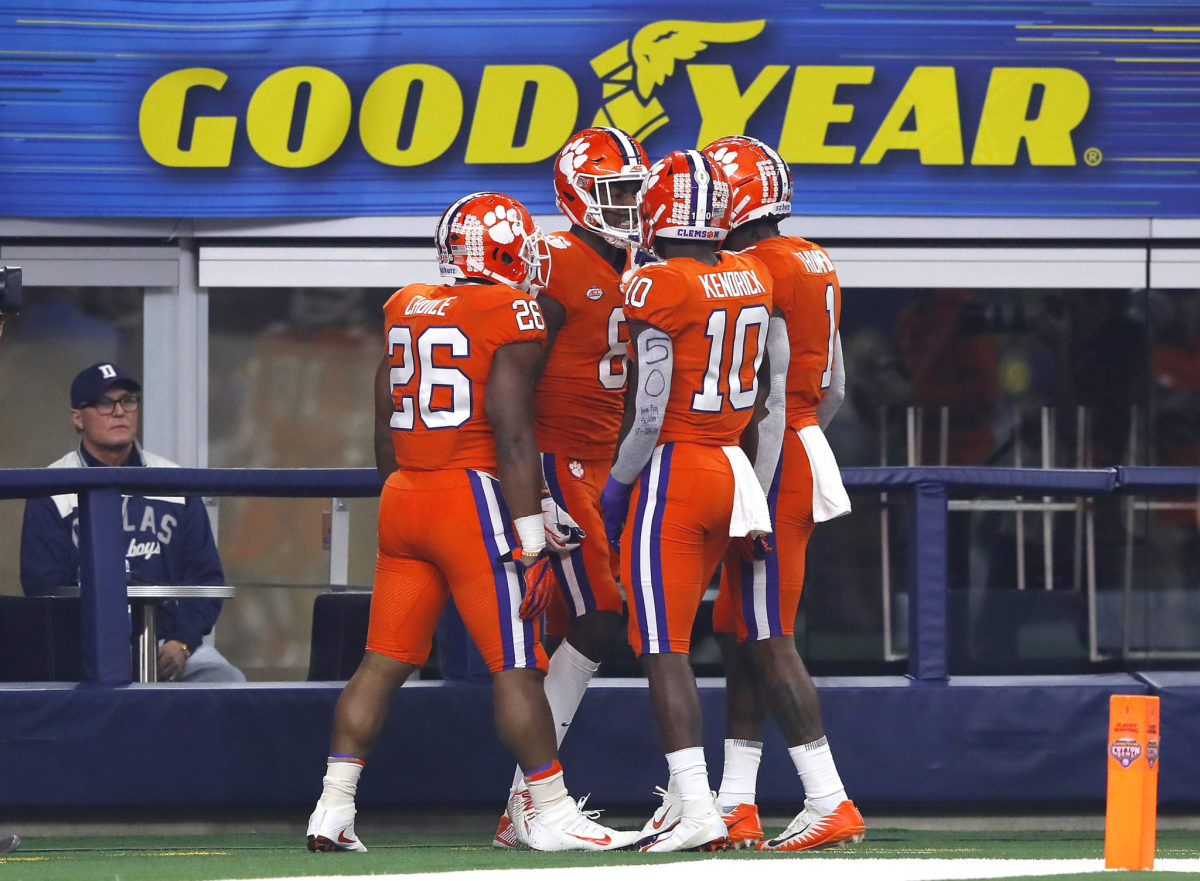 Justyn Ross celebrates with Clemson teammates including Derion Kendrick after touchdown.