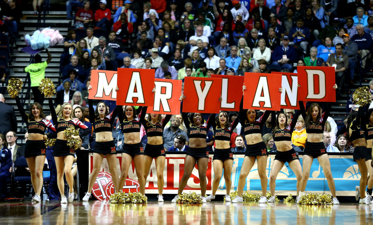 Maryland cheerleaders holding up signs that spell out Maryland.
