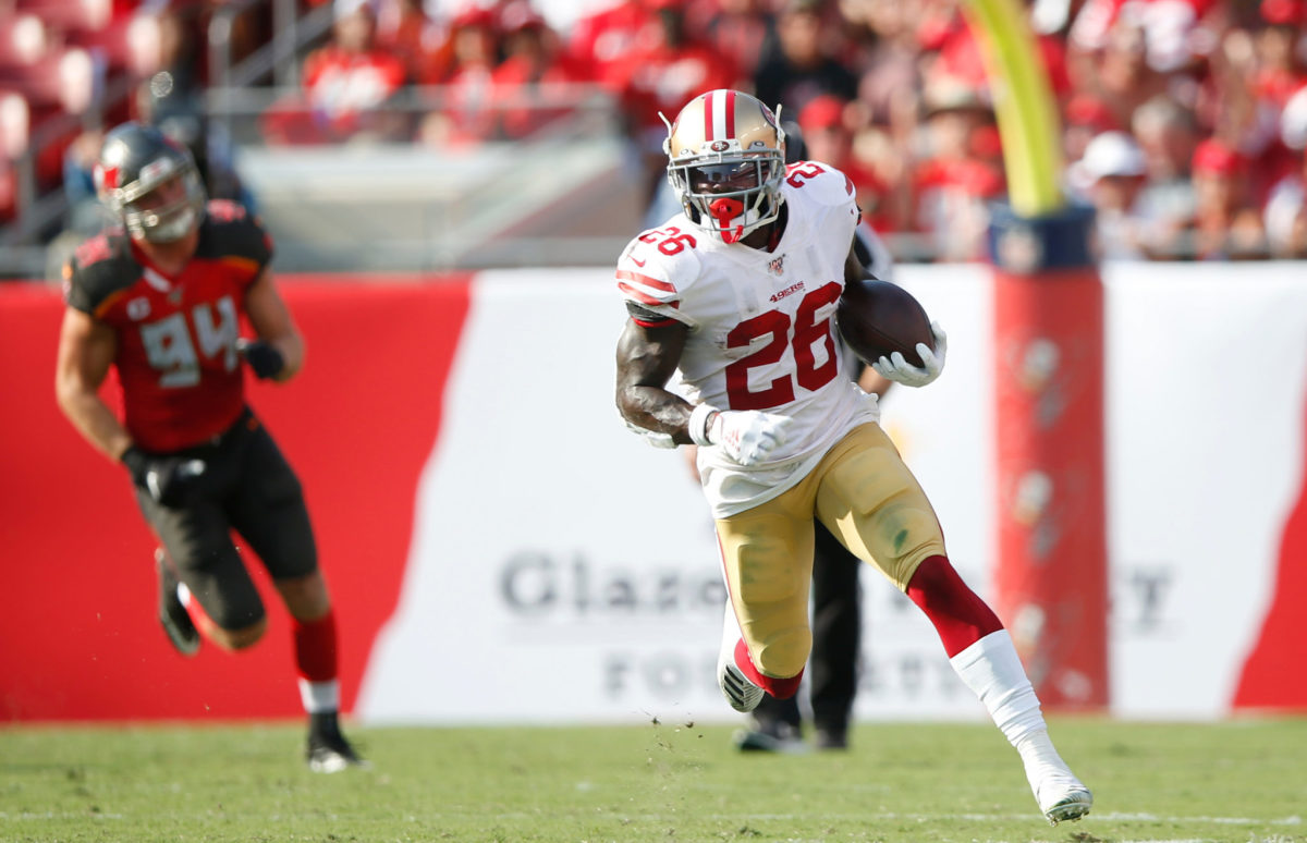 Tevin Coleman runs the football for the San Francisco 49ers.