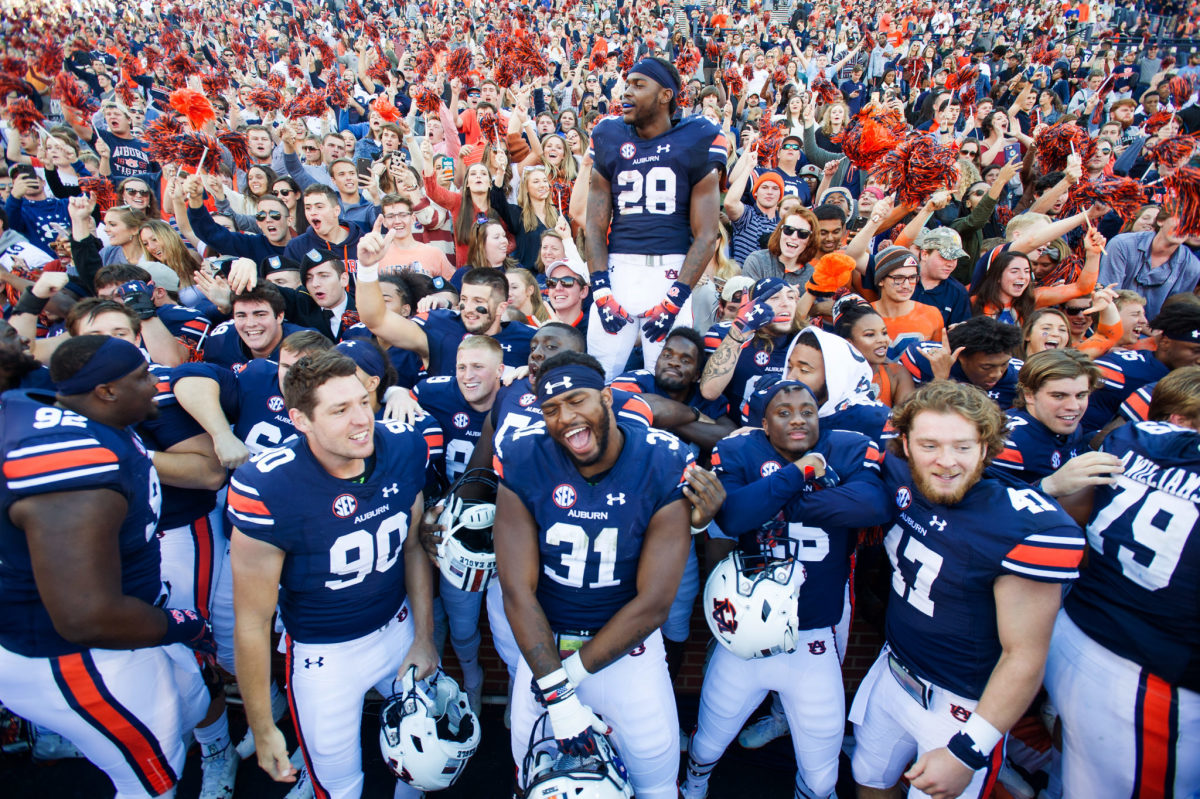 Auburn football players celebrating after a game.