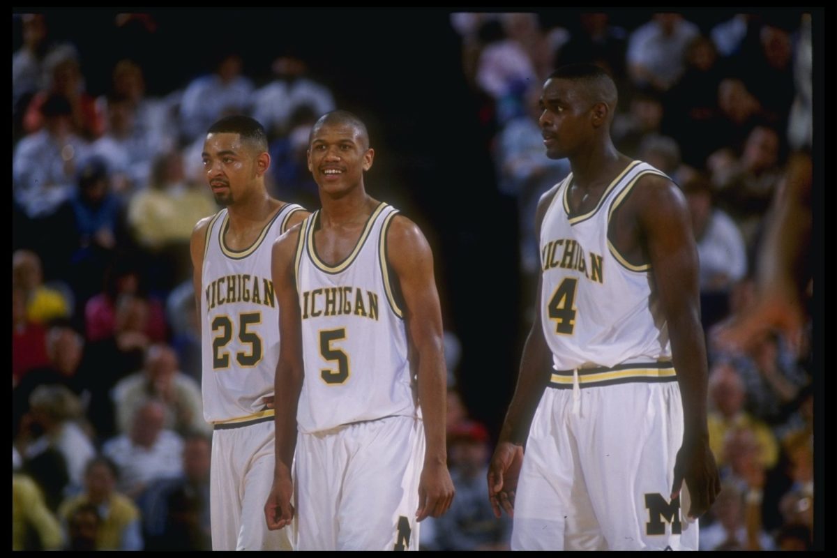 Michigan Wolverines forward Juwan Howard, guard Jalen Rose, and forward Chris Webber (l to r) look on during a game against Indiana.