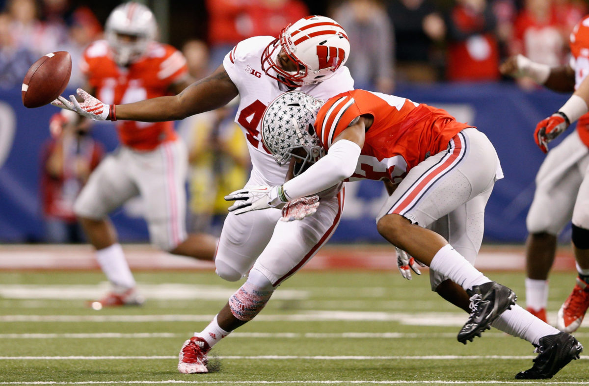 Ohio State's Darron Lee laying a hit on a Wisconsin player.