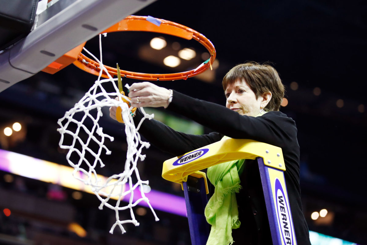Notre Dame head coach Muffet McGraw cuts downw the nets after winning the 2018 national title.