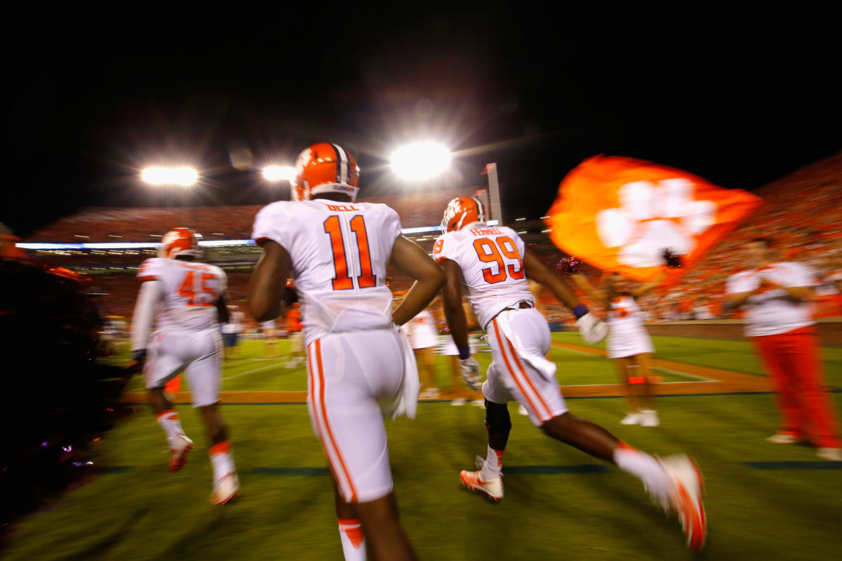 Chris Register #45, Shadell Bell #11 and Clelin Ferrell #99 of the Clemson Tigers run onto the field prior to the game against the Auburn Tigers at Jordan Hare Stadium.