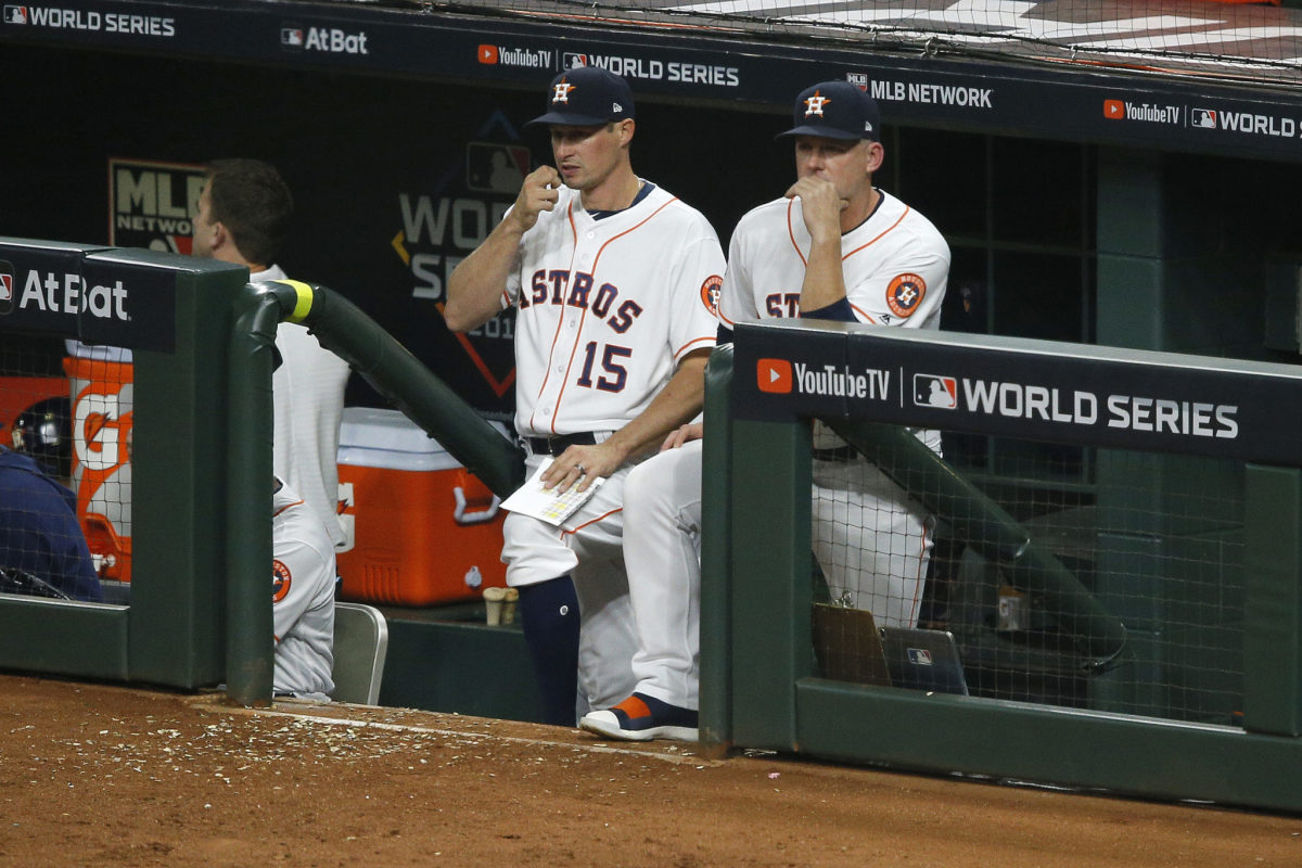 AJ Hinch sits in the Astros dugout.