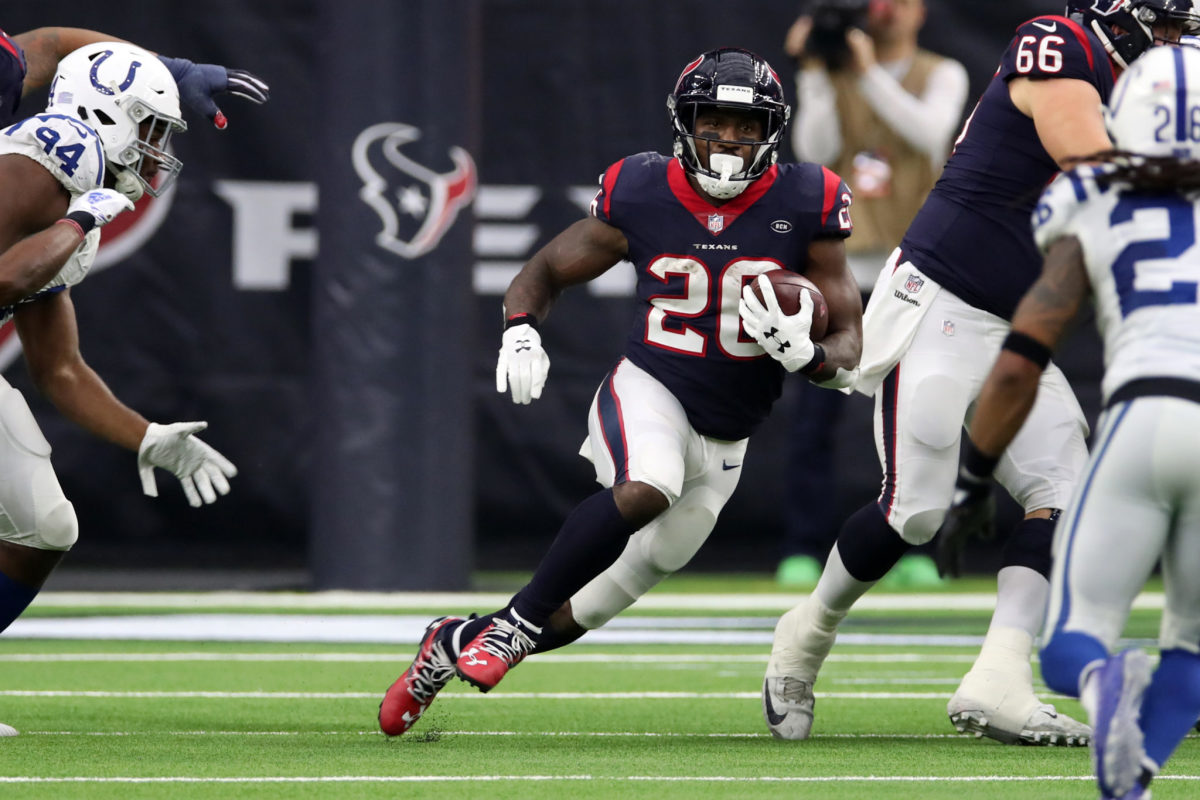 Lamar Miller, now of the New England Patriots, runs for the Houston Texans against the Indianapolis Colts.