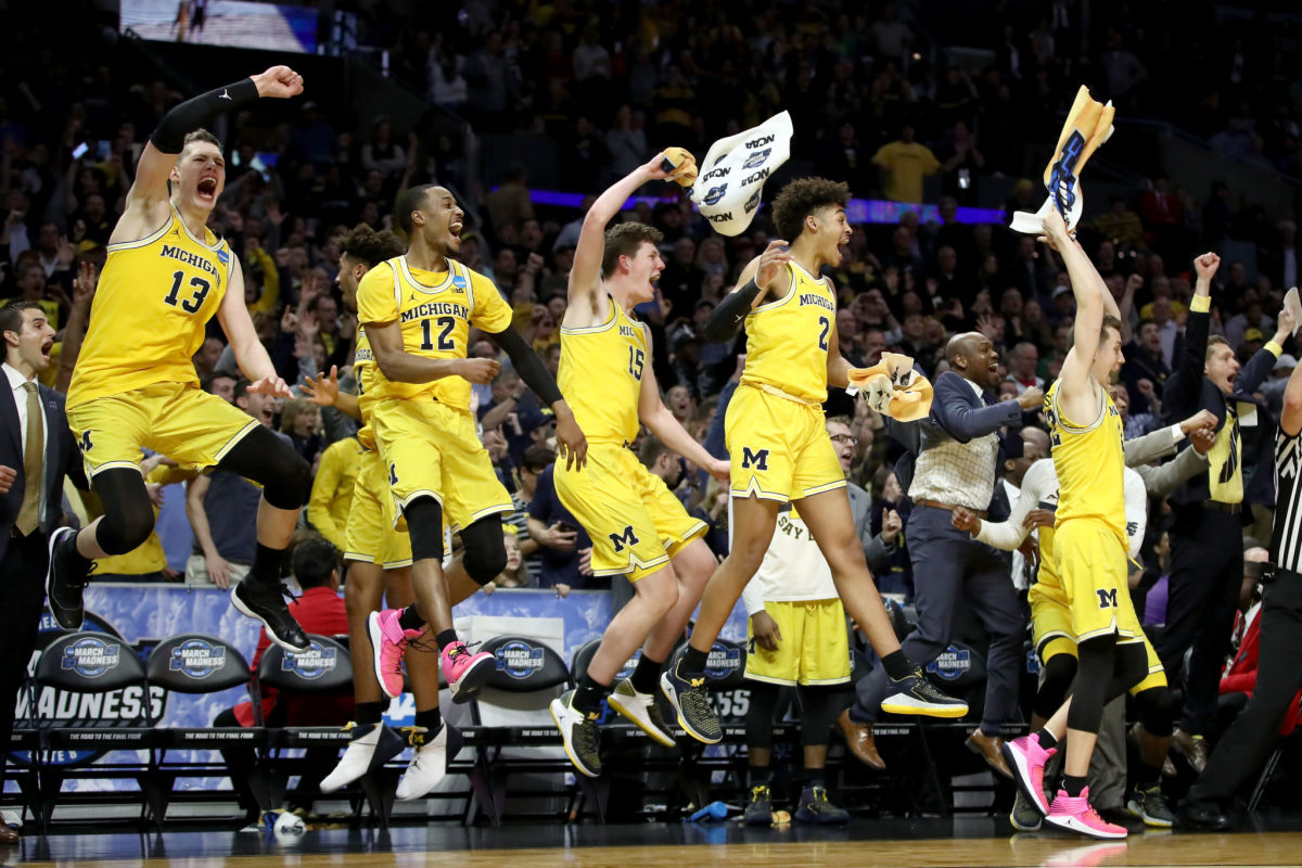 The Michigan Wolverines bench celebrates in the games final minutes against the Texas A&M Aggies.