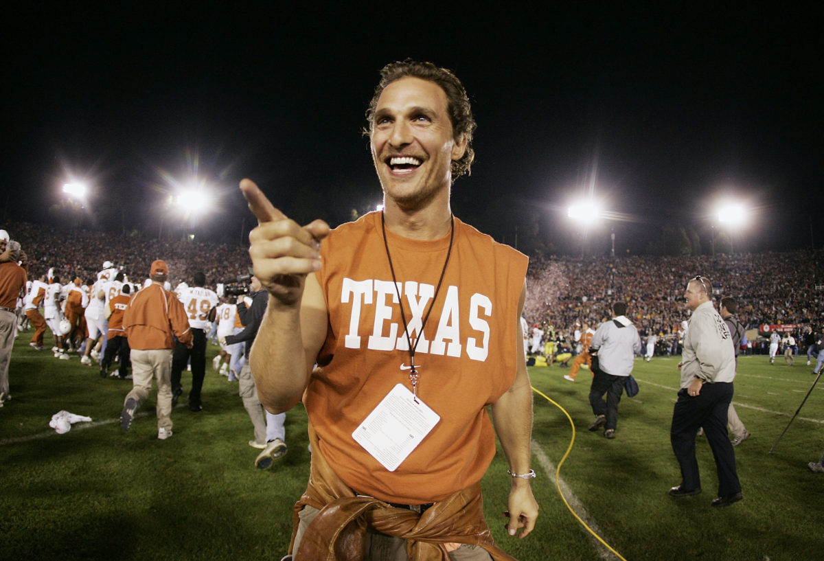 Matthew McConaughey celebrating on the field after a Texas Longhorns game.