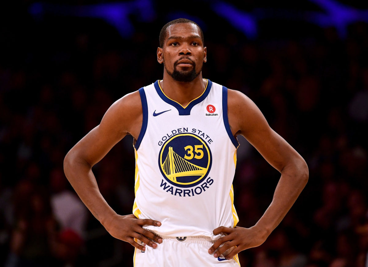A closeup of Kevin Durant with his hands on his waste.