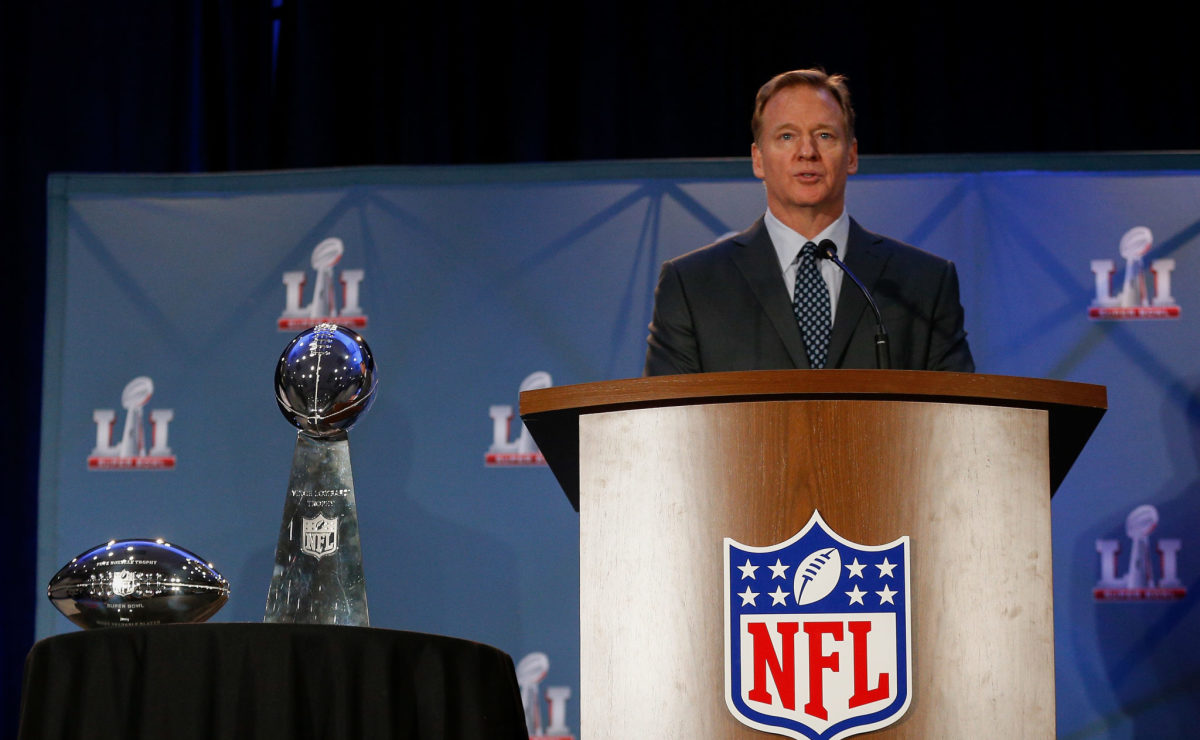 Roger Goodell talking at a podium at the Super Bowl.