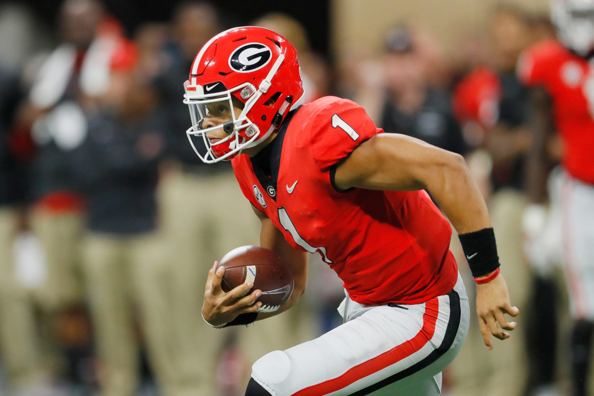 justin fields runs the ball during the sec championship game