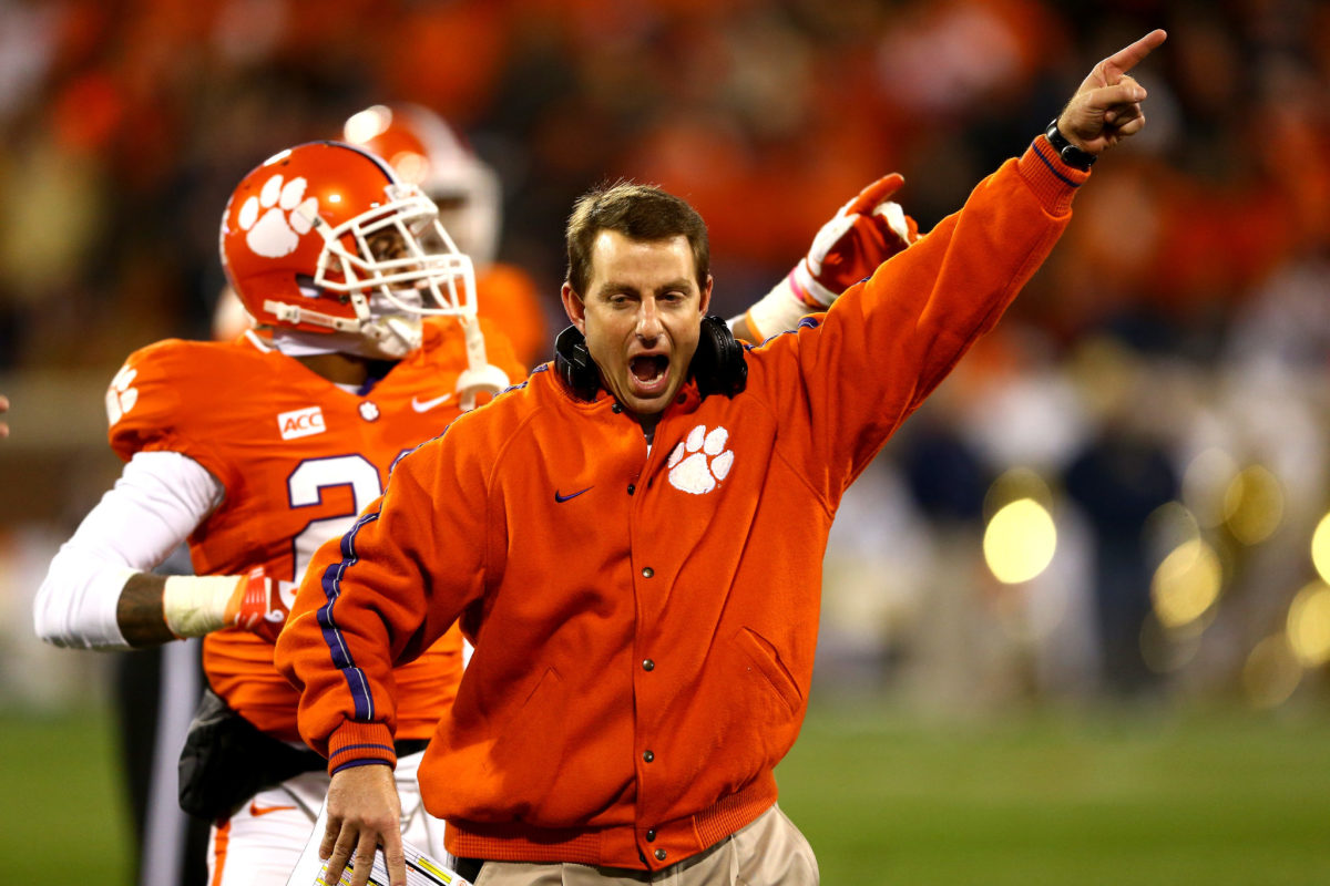 Head coach Dabo Swinney of the Clemson Tigers celebrates after a ruling on the field during their game against the Georgia Tech Yellow Jackets at Clemson Memorial Stadium.