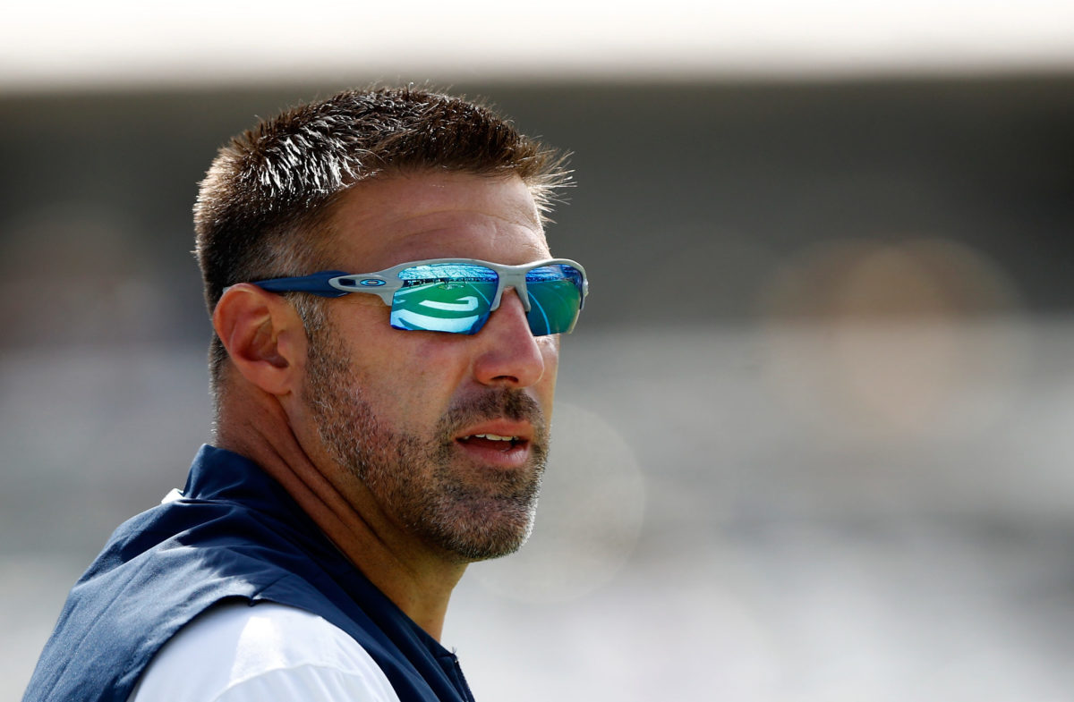 Mike Vrabel wearing sunglasses on the sideline.