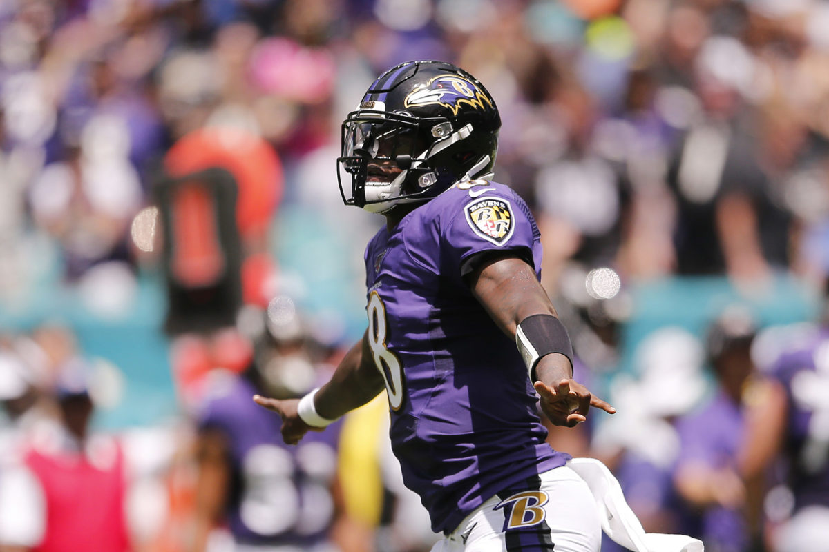 Lamar Jackson throws a touchdown pass to Hollywood Brown during a Baltimore Ravens game.