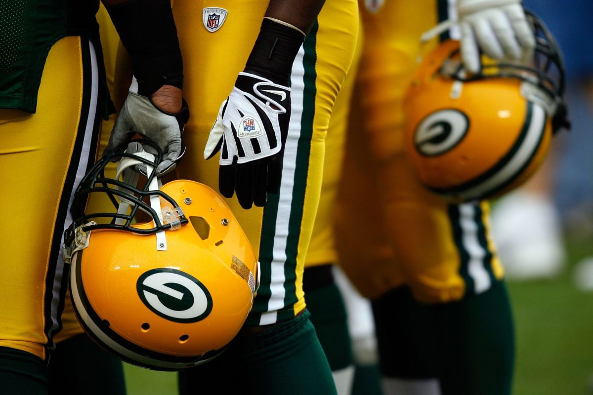 A view of Green Bay Packers players holding their helmets.