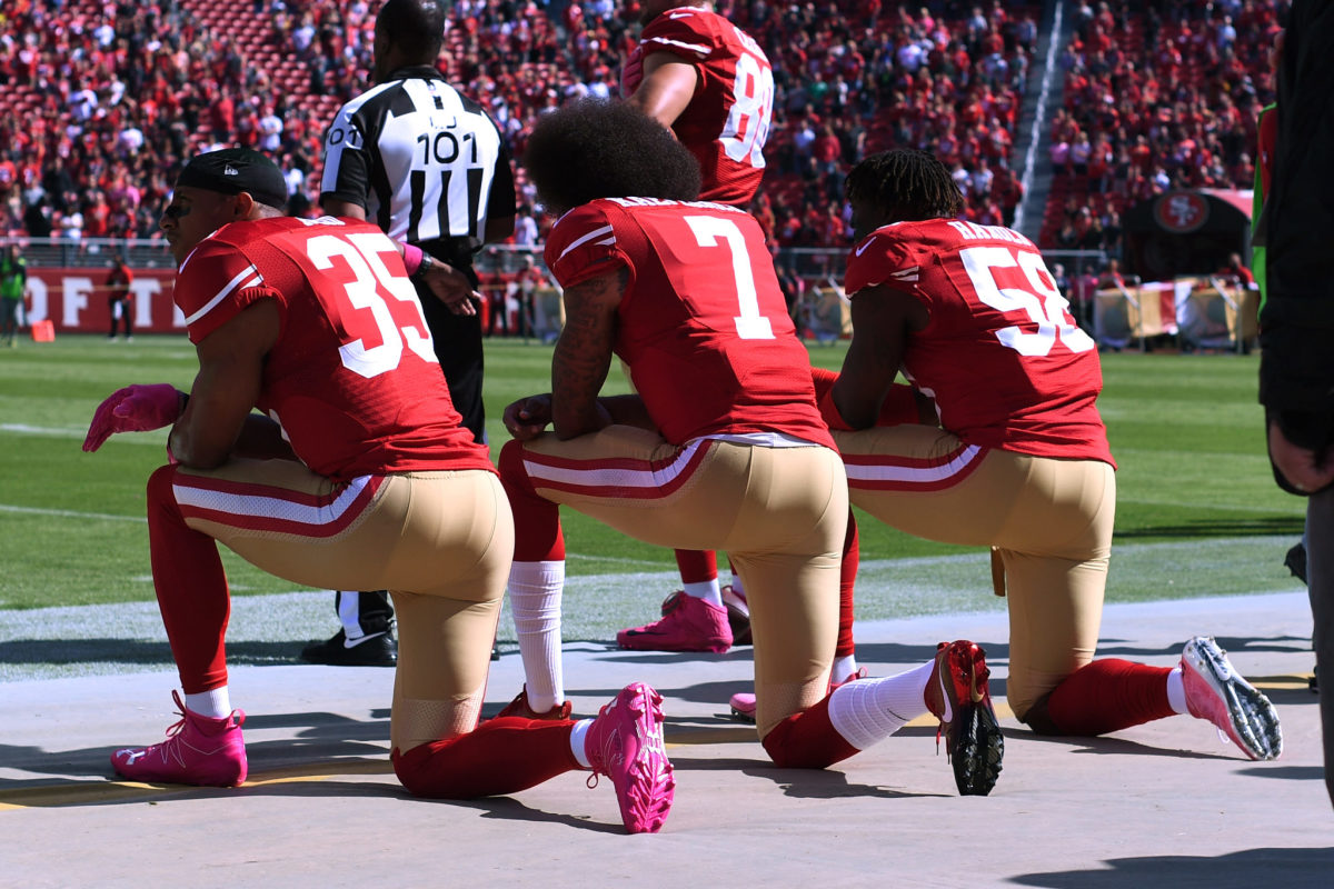 49ers players take a knee during Sunday game.