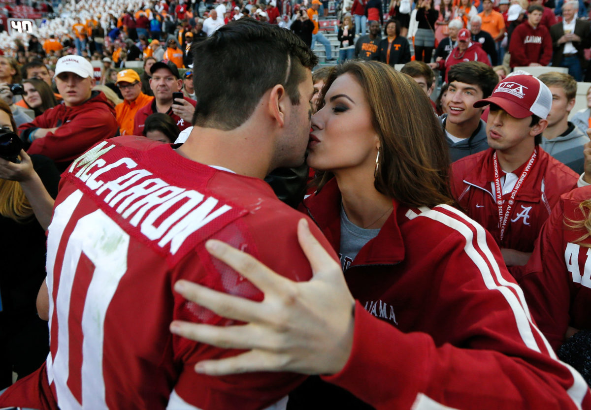 AJ McCarron kisses Katherine Webb after a game.