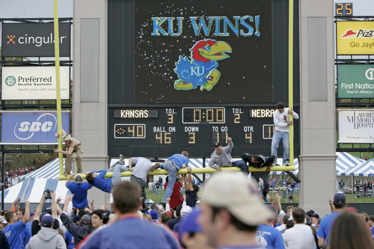 Kansas fans tearing down the goal post after the football team wins.