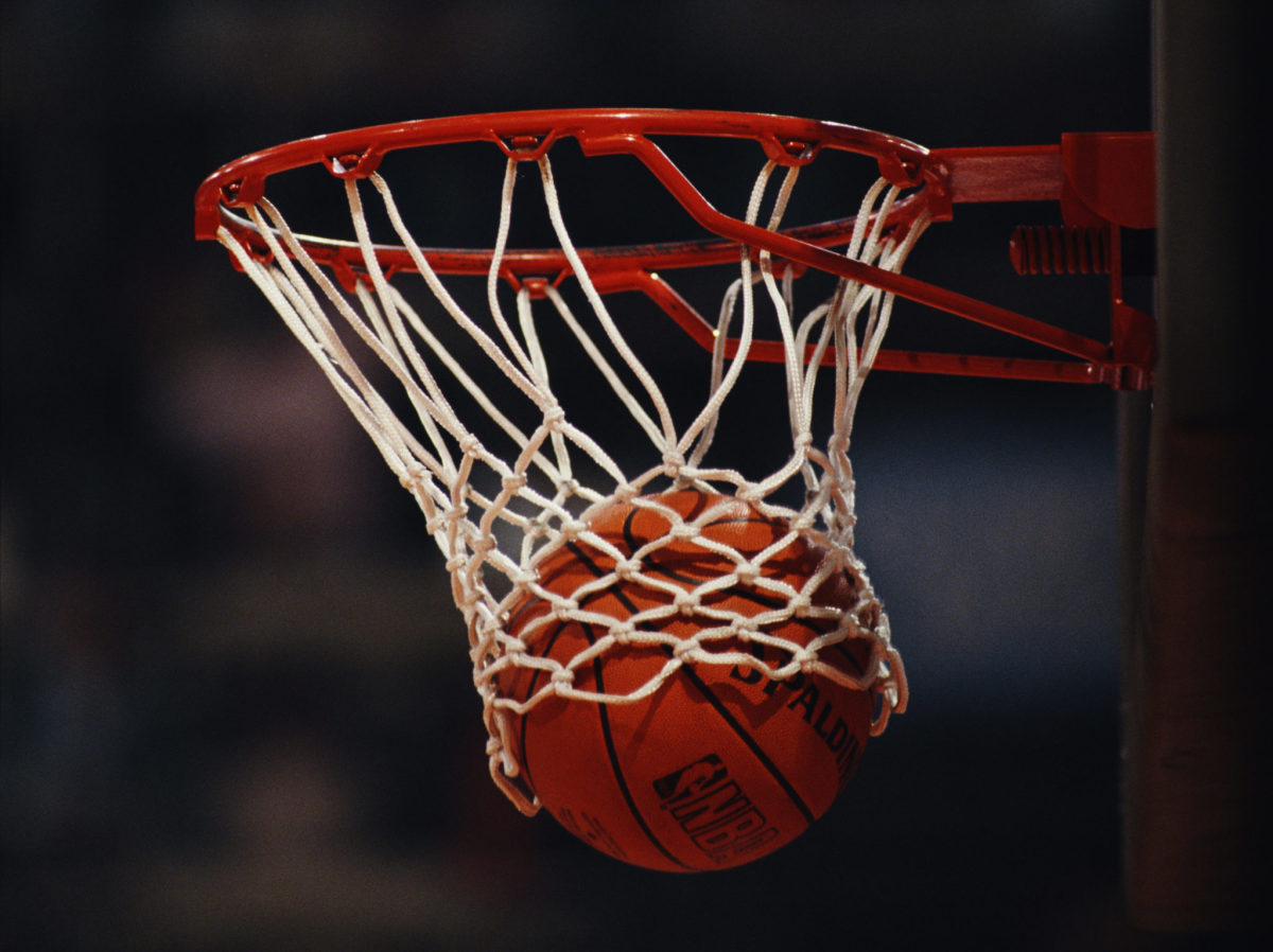 photo of a basketball going through the net