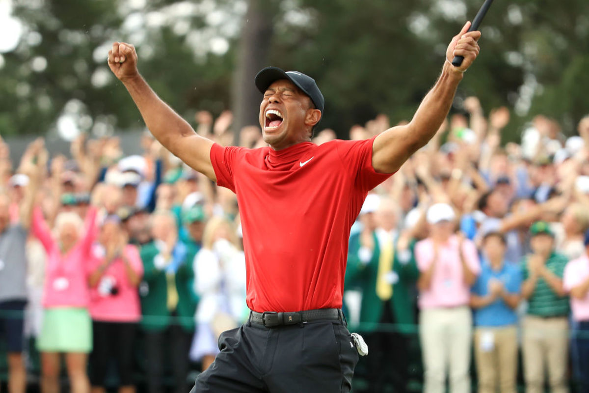 Tiger Woods celebrates after making the final putt of his Masters victory.