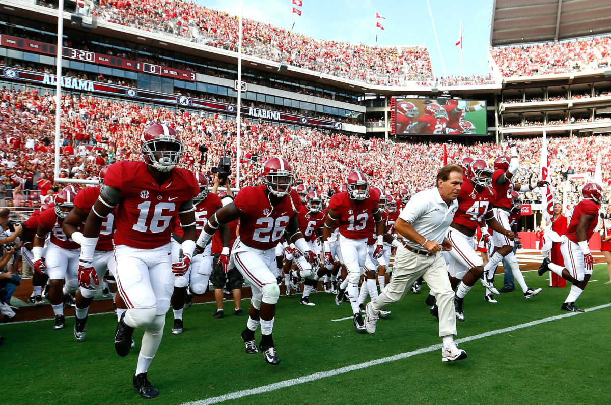 Head coach Nick Saban of the Alabama Crimson Tide leads his team on the field to face the Southern Miss Golden Eagles at Bryant-Denny Stadium.