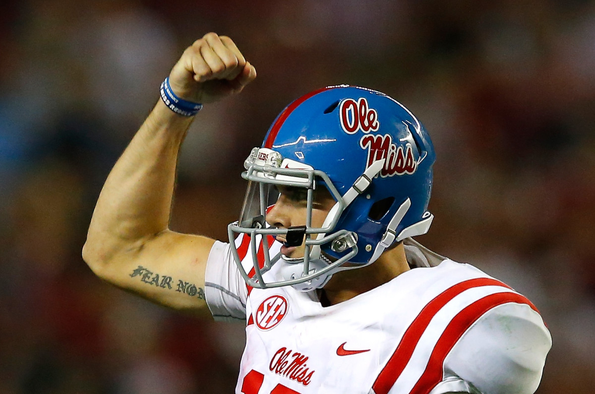 Chad Kelly shows off his bicep after a big play.