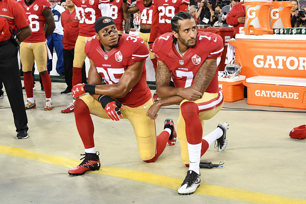 Colin Kaepernick #7 and Eric Reid #35 of the San Francisco 49ers kneel in protest during the national anthem.