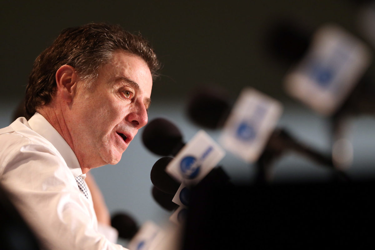 College basketball coach Rick Pitino answers questions from reporters.