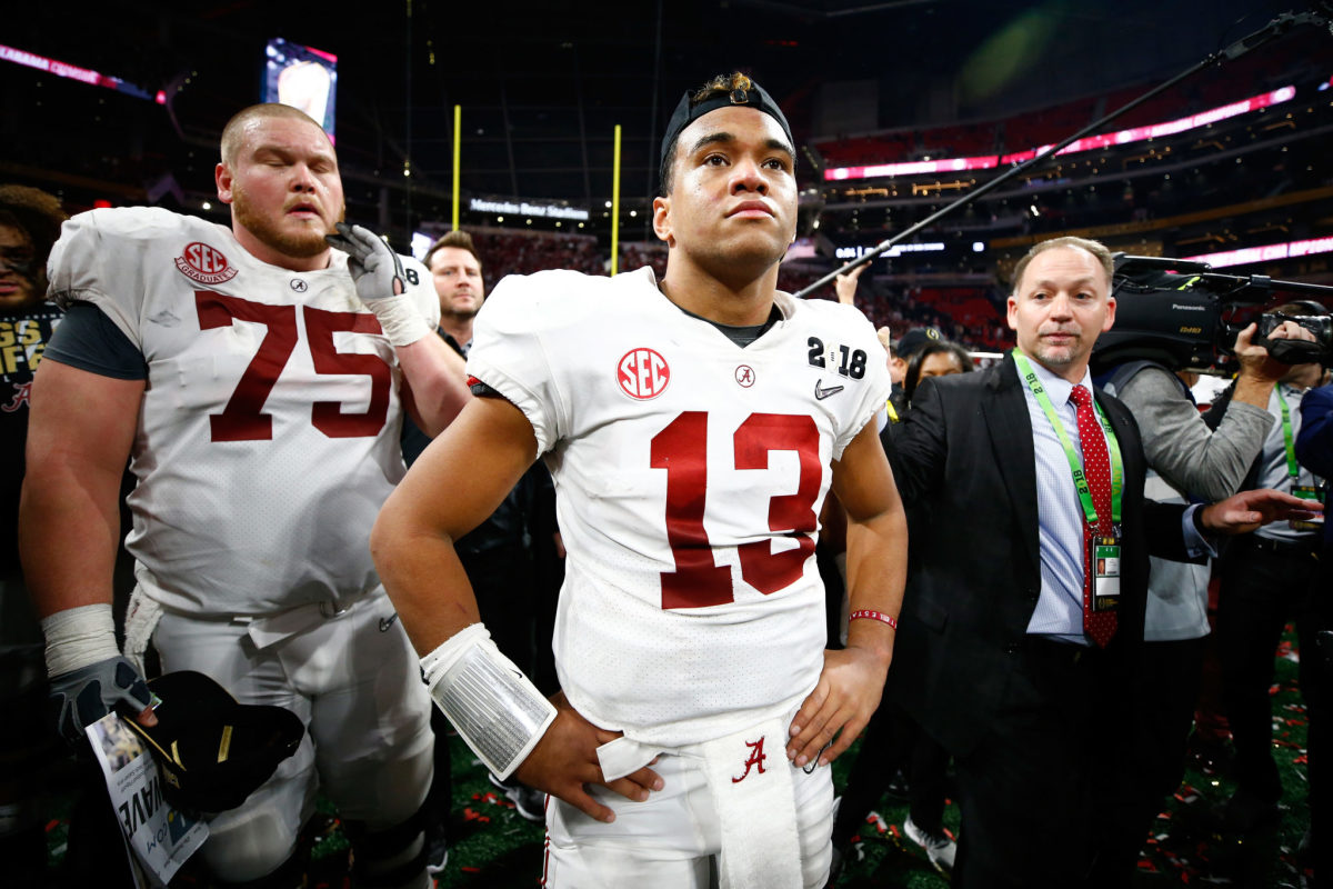 Tua Tagovailoa of the Alabama Crimson Tide stands on the field after beating the Georgia Bulldogs in overtime to win the CFP National Championship.