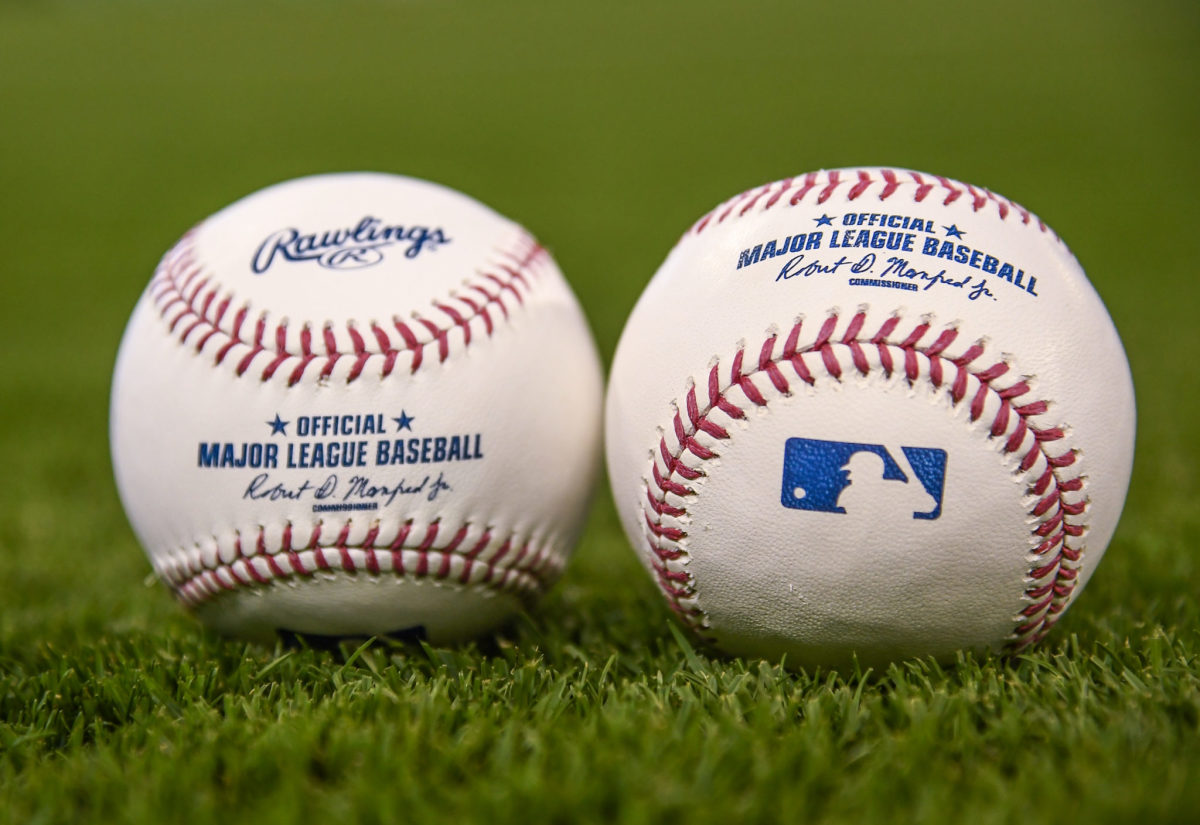 A generic photo of two baseball's sitting side-by-side on a field.