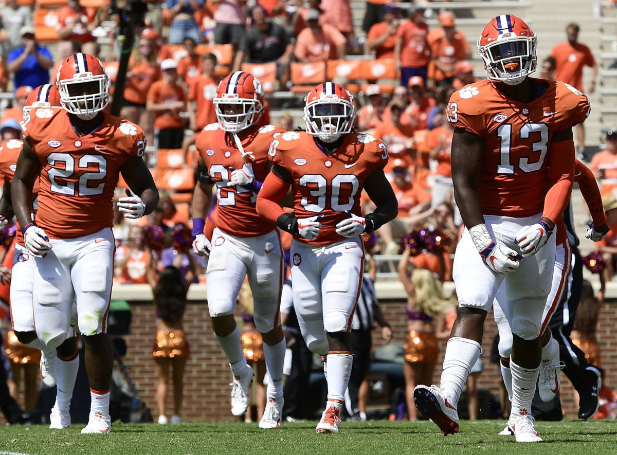 Clemson players run off the field after a forced fumble vs. Furman.