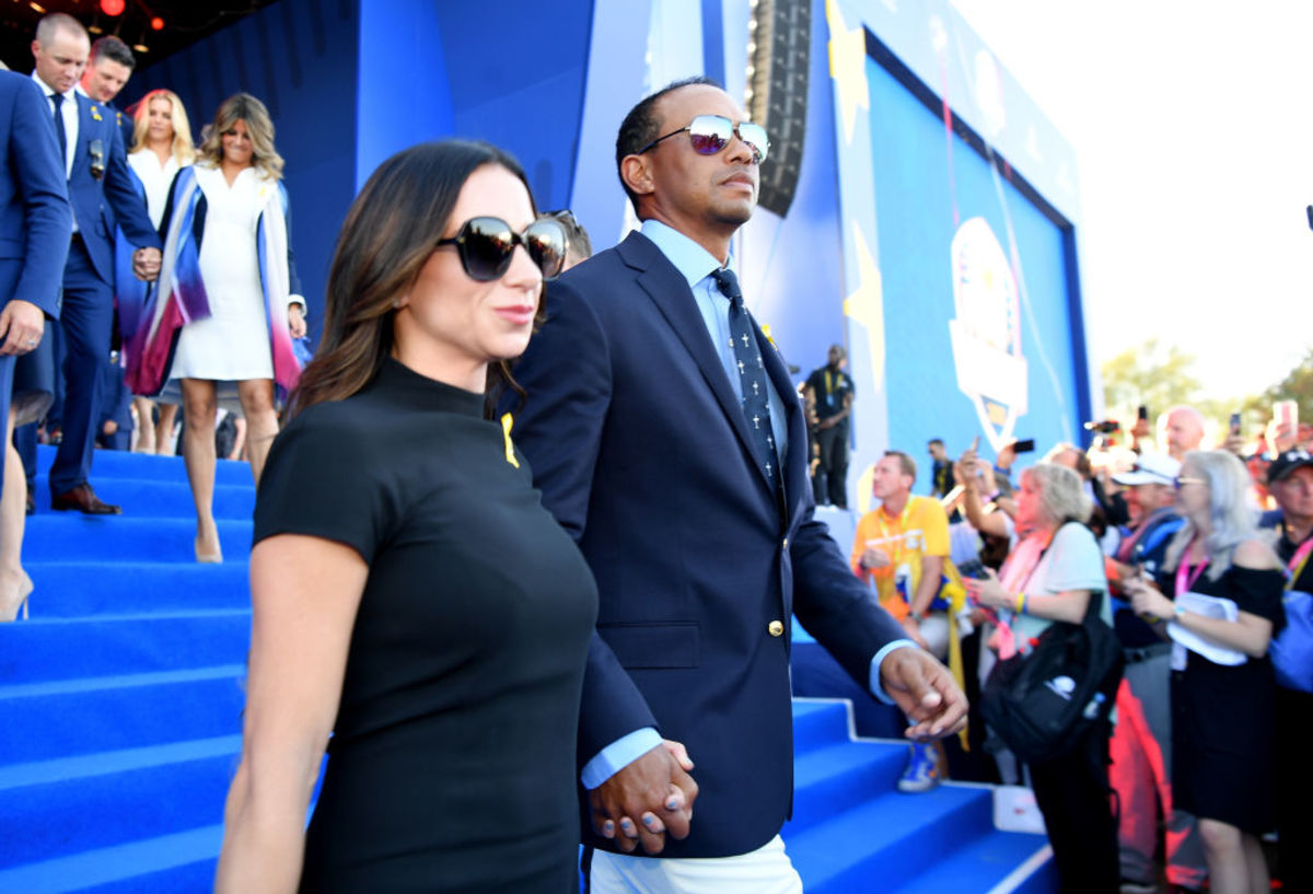 Tiger Woods walking with his girlfriend.