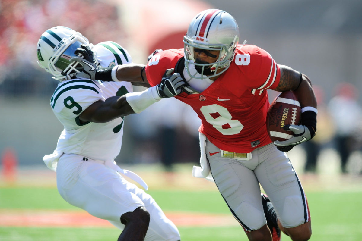 DeVier Posey stiff arms a defender during a game with Ohio State.