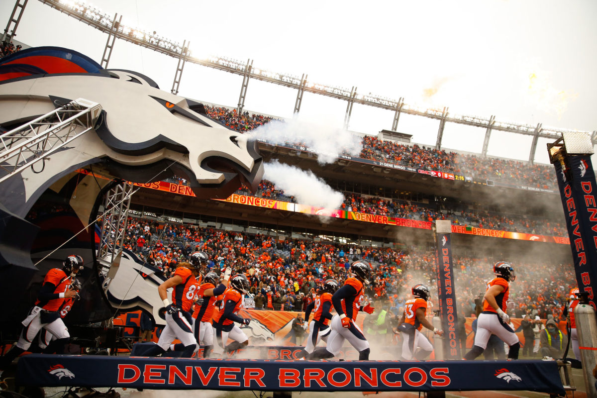 The Denver Broncos running out onto the field.