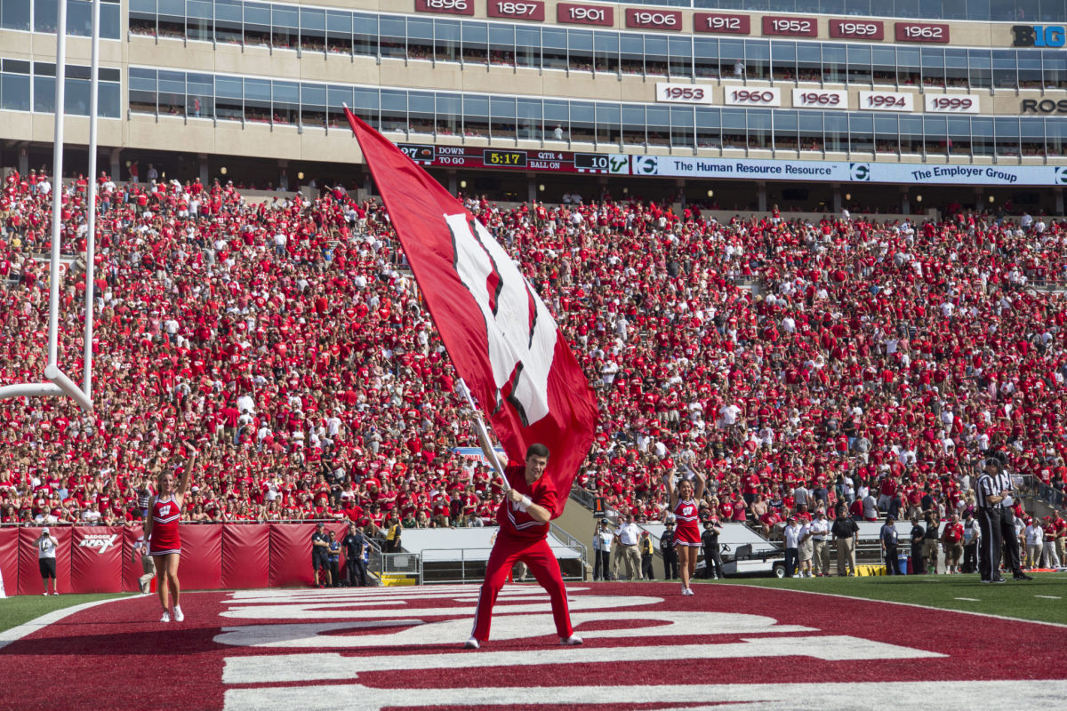 Wisconsin's cheerleader waves the flag in the end zone for Badgers fans.